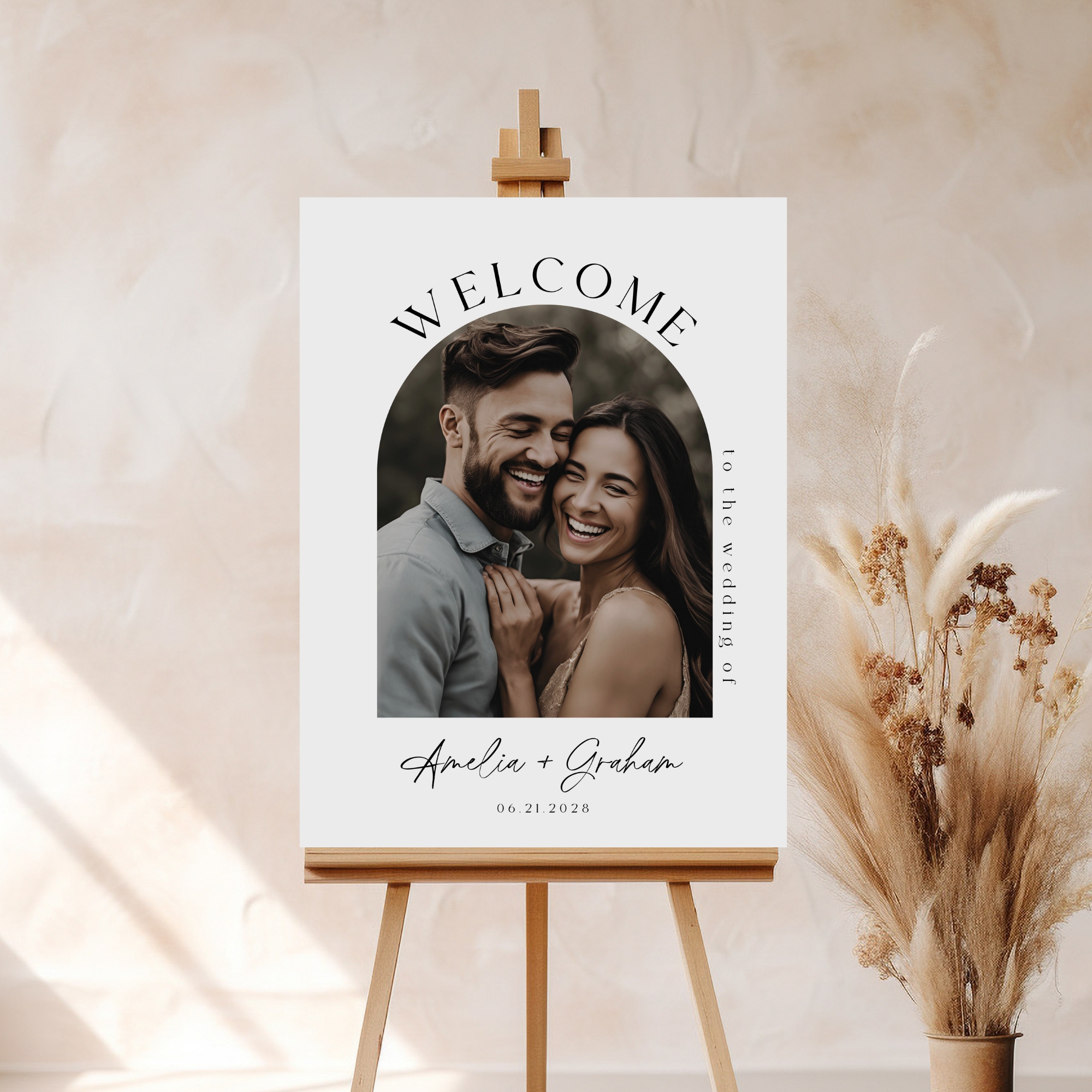 Welcome sign with a photo of a couple on an easel against a beige background