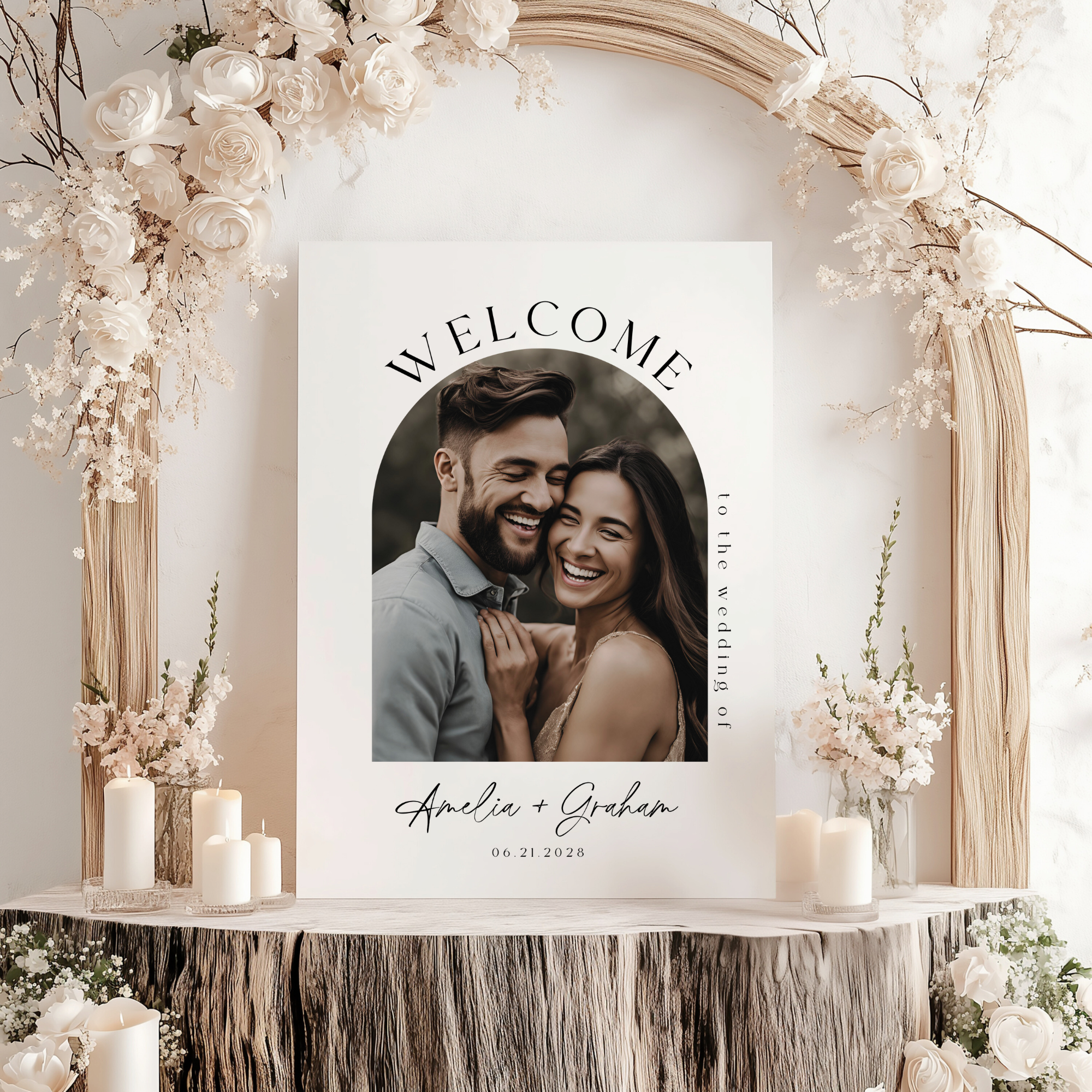 Decorative welcome sign with a couple's photo and 'Welcome' text, surrounded by floral arrangements and candles.